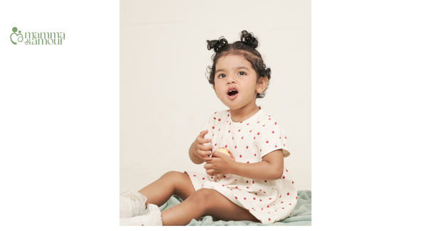 Baby sitting in apple print waffled organic cotton playsuit, GOTS certified clothing by Mamma & Amour