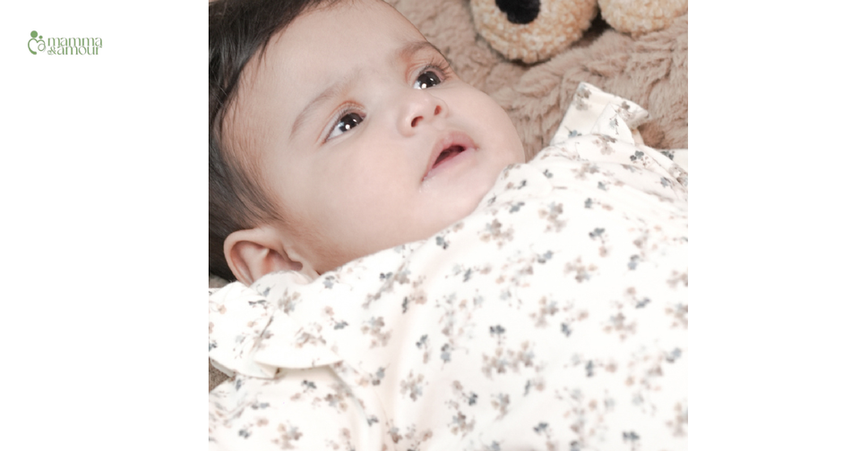 Newborn baby wearing organic cotton floral sleepsuit - GOTS certified newborn clothing India
