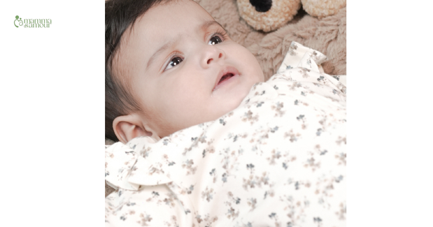 Newborn baby wearing organic cotton floral sleepsuit - GOTS certified newborn clothing India